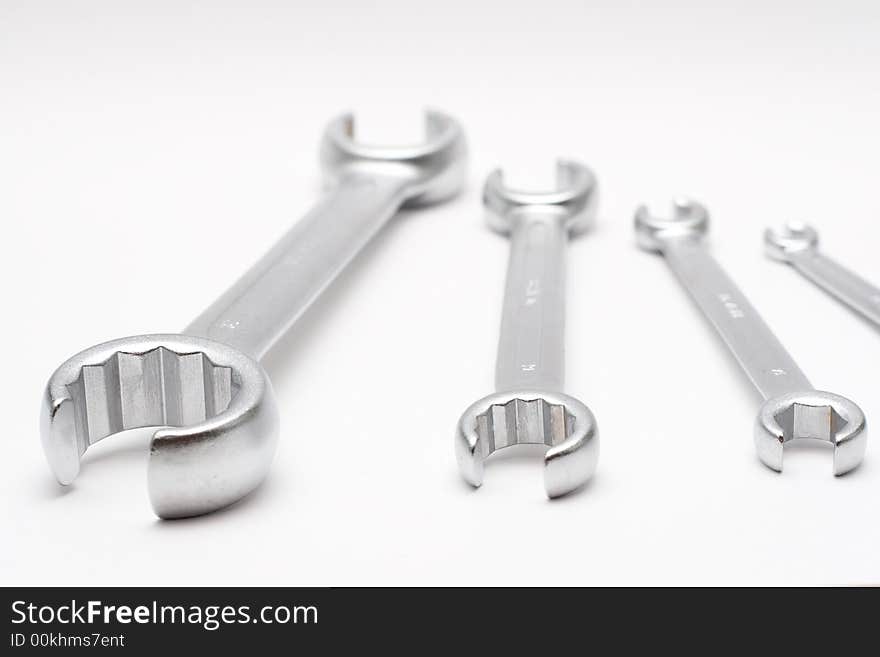 Four wrenches isolated on semi-white background