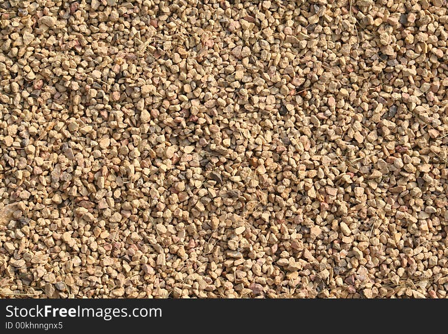 Close up at Small stones with pieces of grass good as a background. Close up at Small stones with pieces of grass good as a background