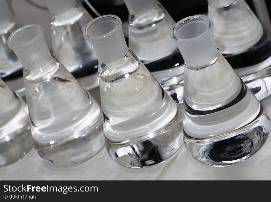 Erlenmeyer flasks with colorless liquid in chemistry lab. Erlenmeyer flasks with colorless liquid in chemistry lab