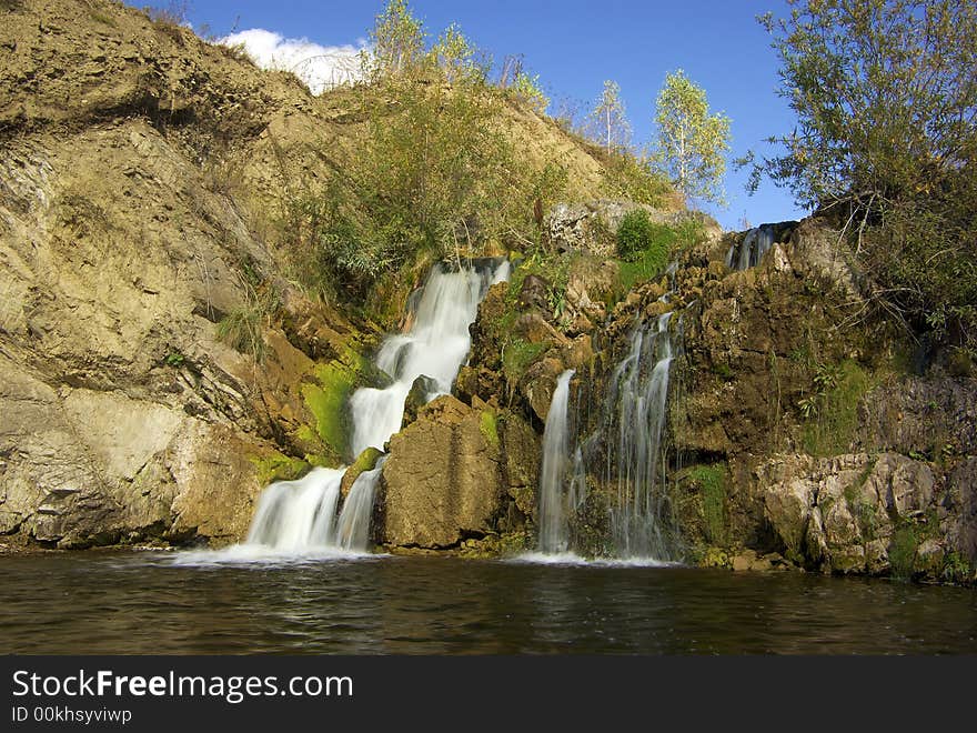 Waterfall on the yellow rocks