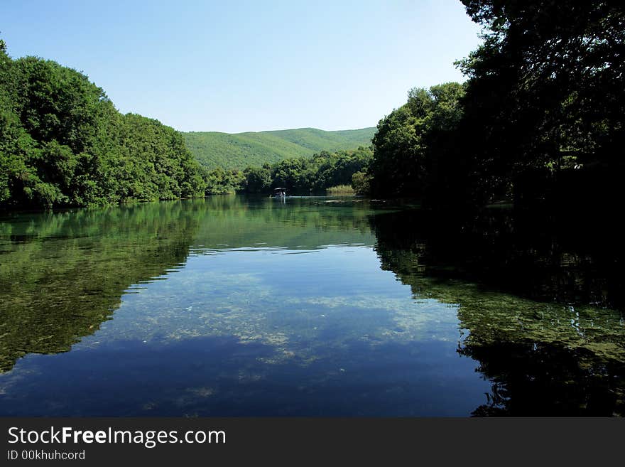 Lake landscape with forest in a background