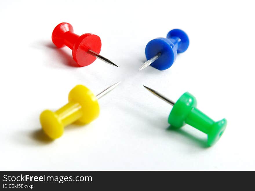 Four attractive colour pins pointing each other