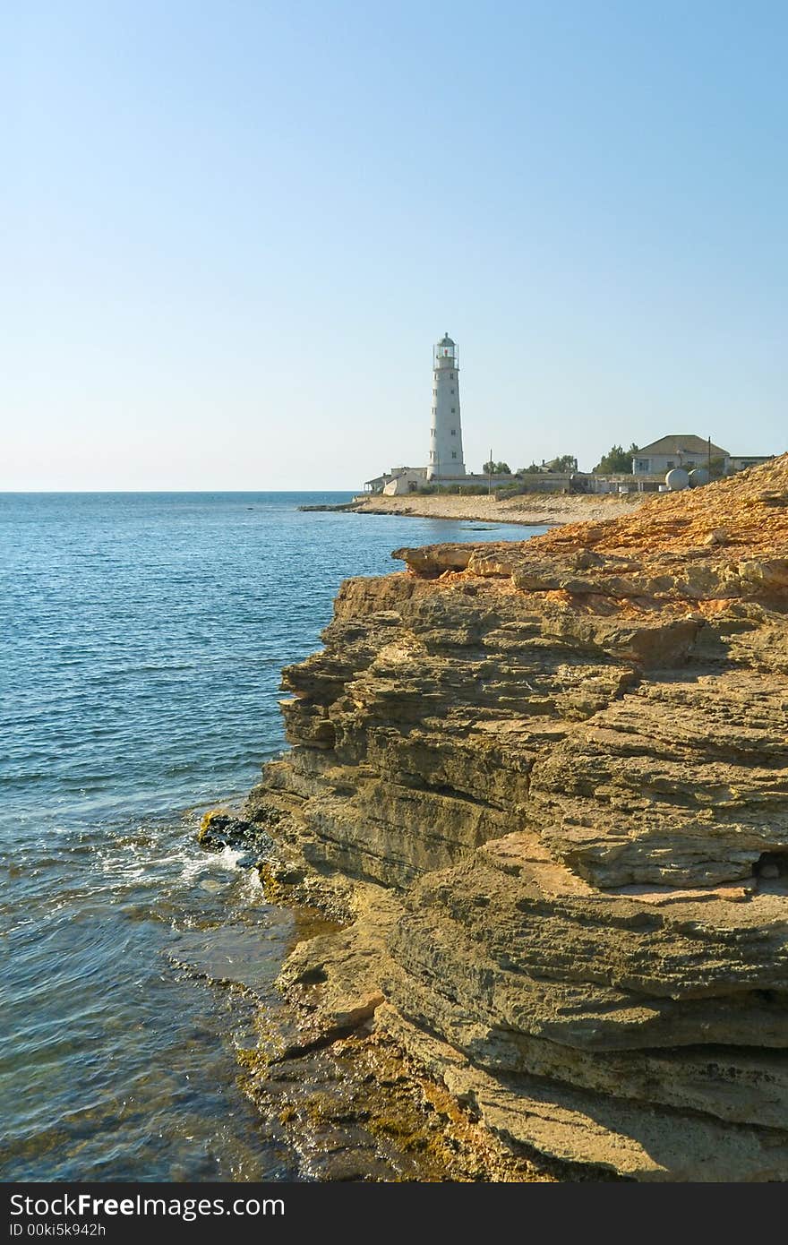 Lighthouse, sea and rock, blue sky