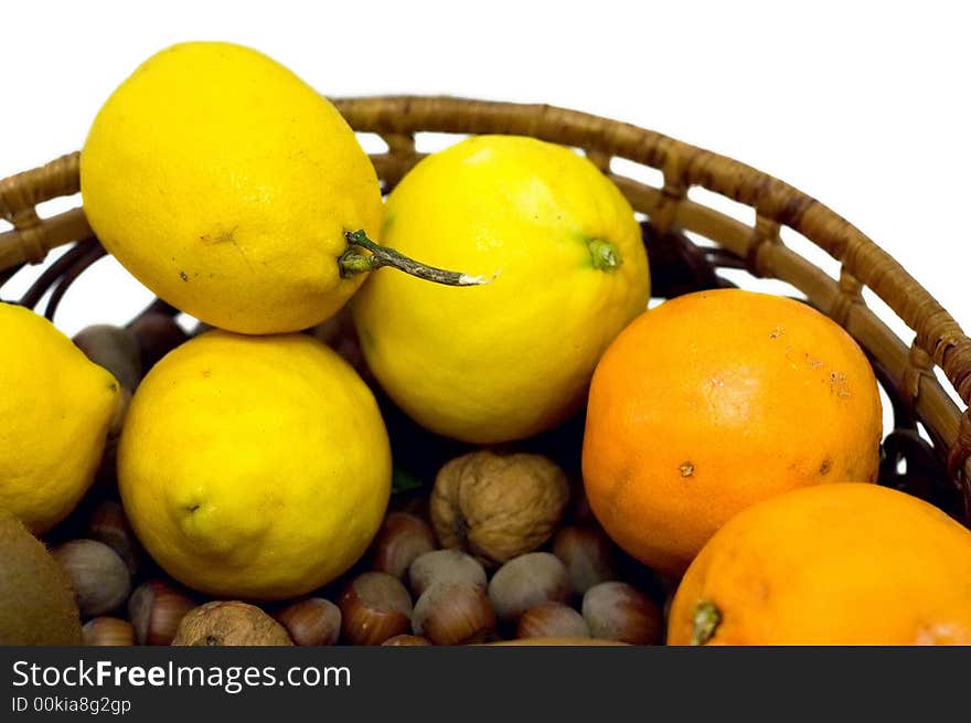 Lemon, oranges and hazelnuts isolated on white. Lemon, oranges and hazelnuts isolated on white