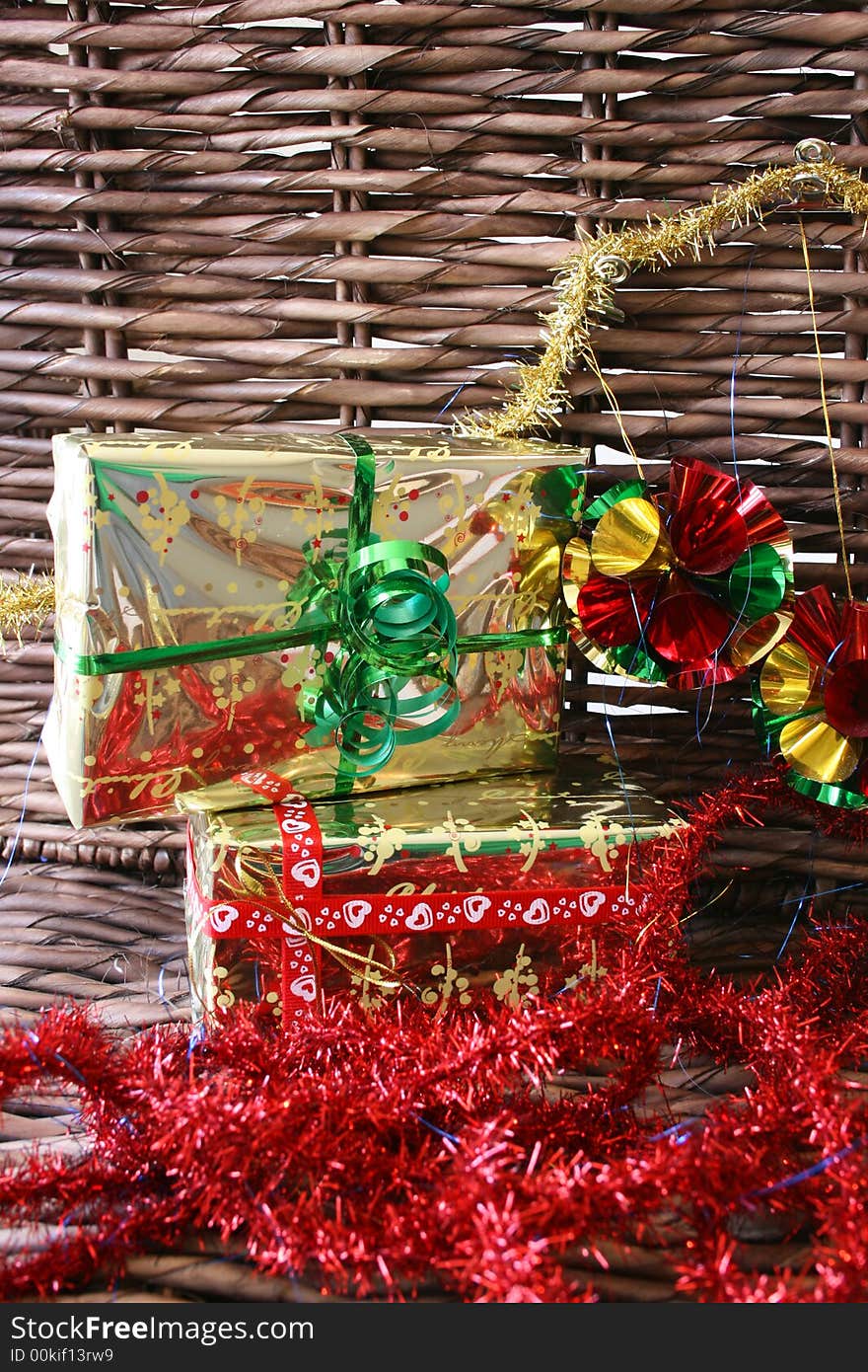 Christmas presents, tinsel and decorations on a rustic background