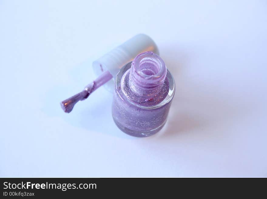 Purple Nail Polish and applicator on a white background