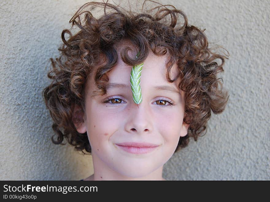 Tobacco horn worn crwling on boy's face. Tobacco horn worn crwling on boy's face