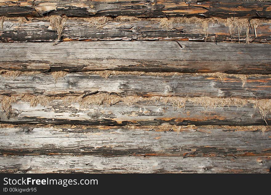 Texture of calked wooden wall made of logs. Buildings with such walls very common in north regions of Russia. Texture of calked wooden wall made of logs. Buildings with such walls very common in north regions of Russia.