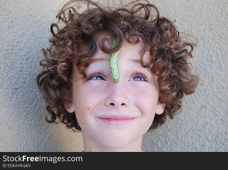 Tobacco horn worn crwling on boy's face. Tobacco horn worn crwling on boy's face