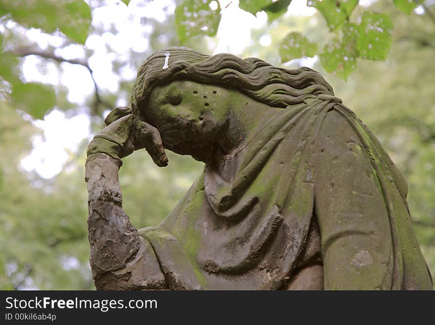 A sculpture of the mourning woman. Old graveyard.