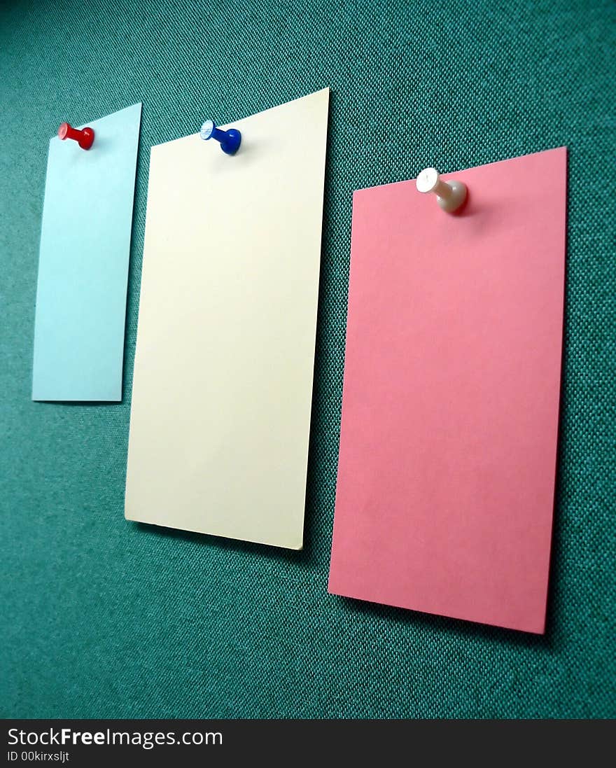 Three blank memos posted on the wall of a modular office cubible. Three blank memos posted on the wall of a modular office cubible