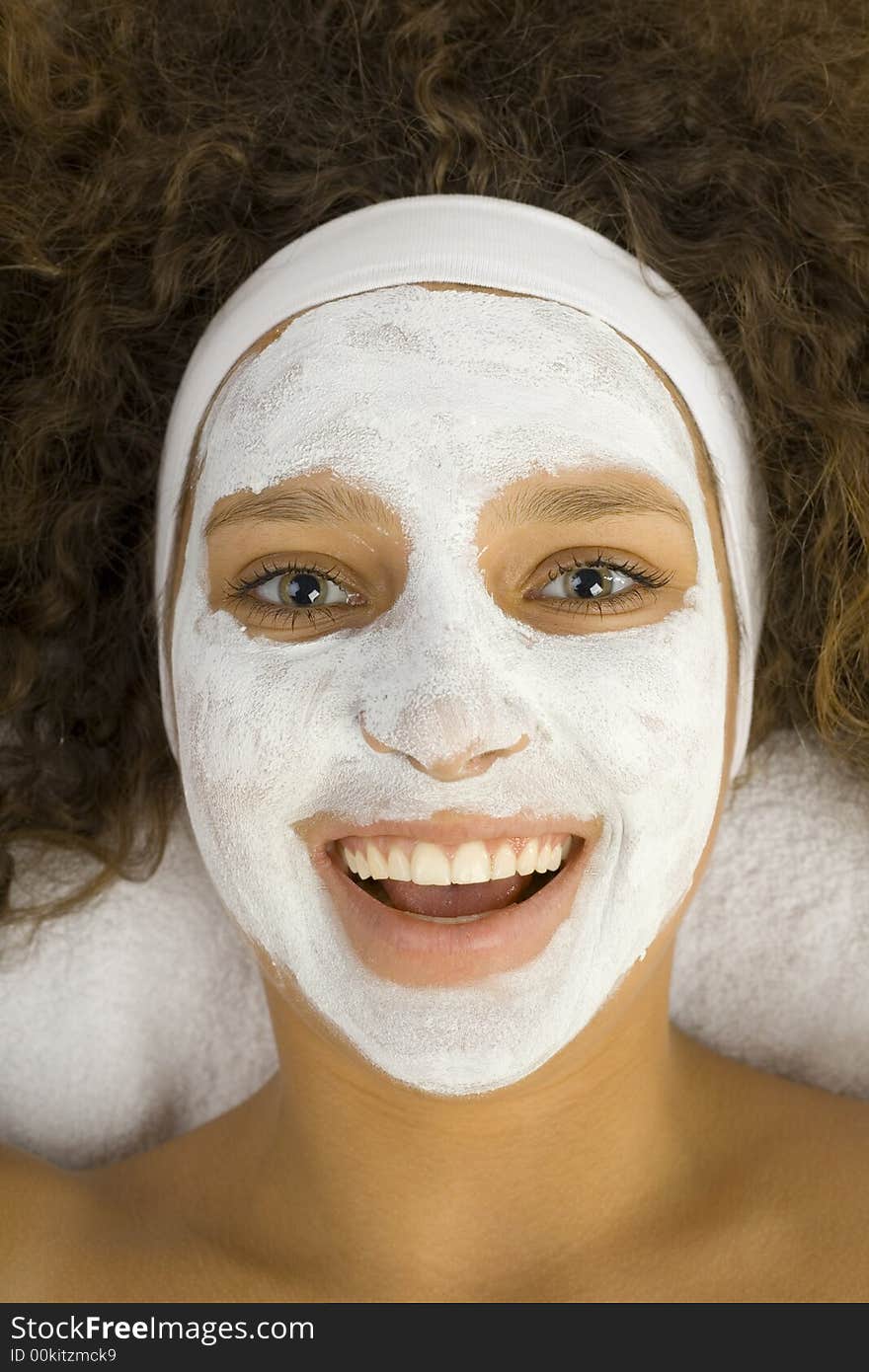 Young happy woman with white purifying mask. She looking at camera. Young happy woman with white purifying mask. She looking at camera.