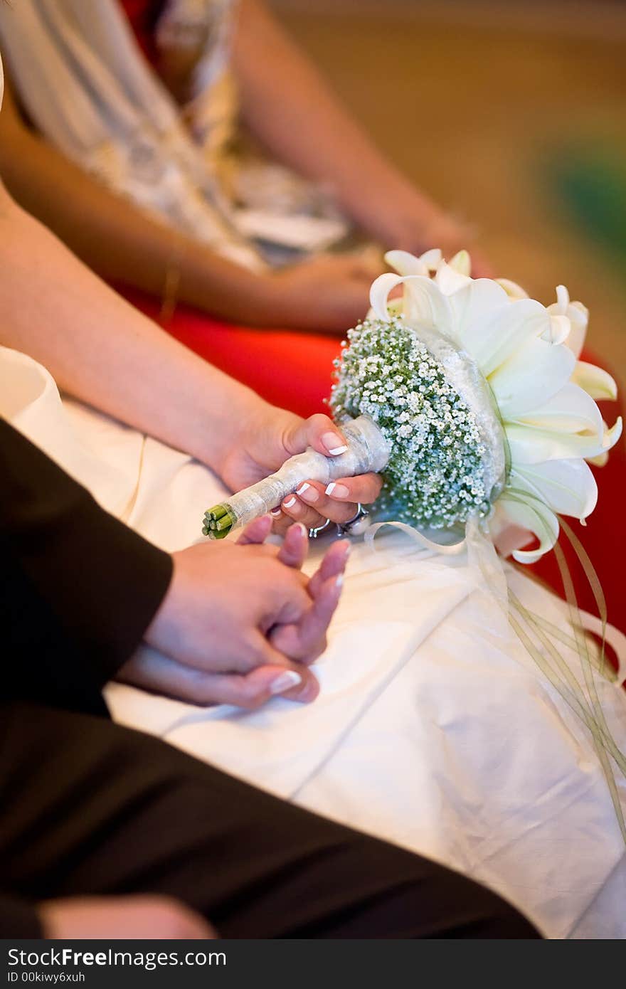 Bridal couple holding their hands while wedding-ceremony. Closeup to the hands. Bridal couple holding their hands while wedding-ceremony. Closeup to the hands.