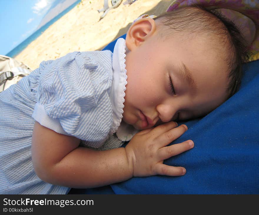 Baby sleeping on the beach