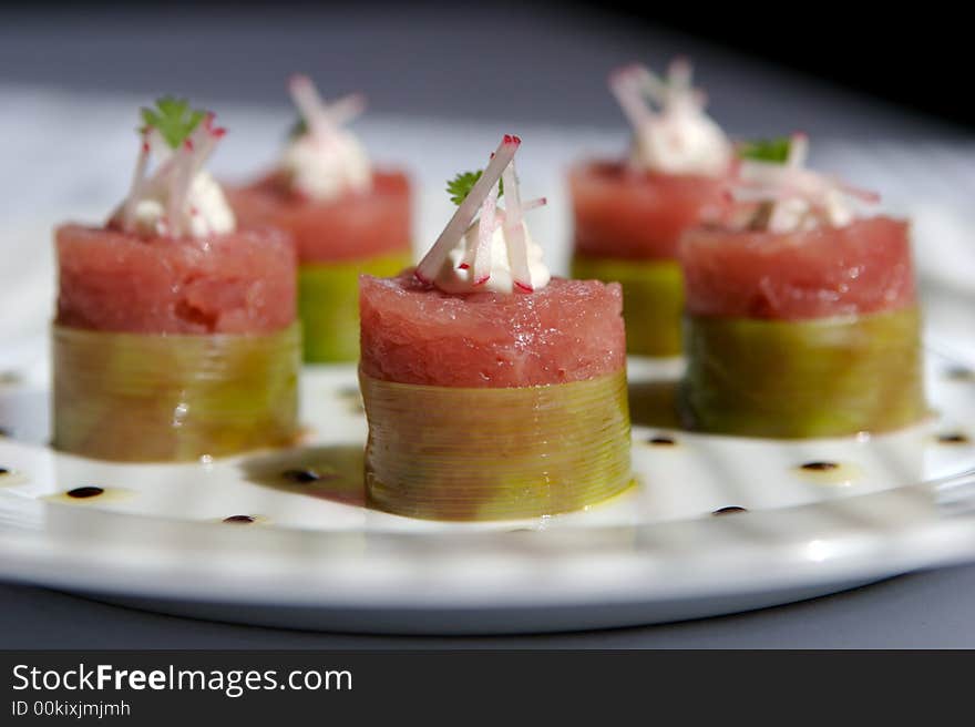 Five Tuna sushi with raddish rolled on a white plate