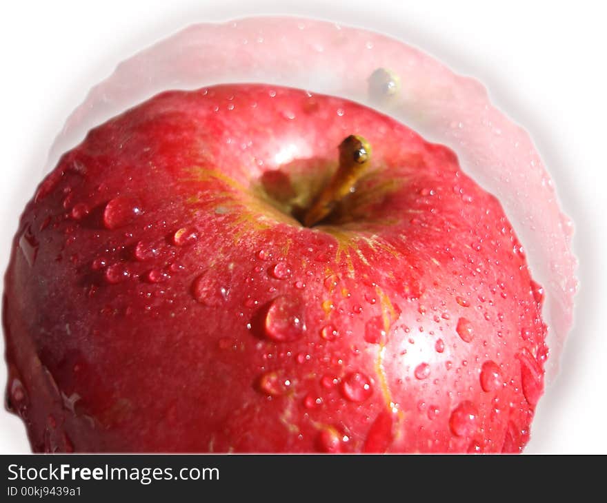 The big, juicy, red apple in drops of water.