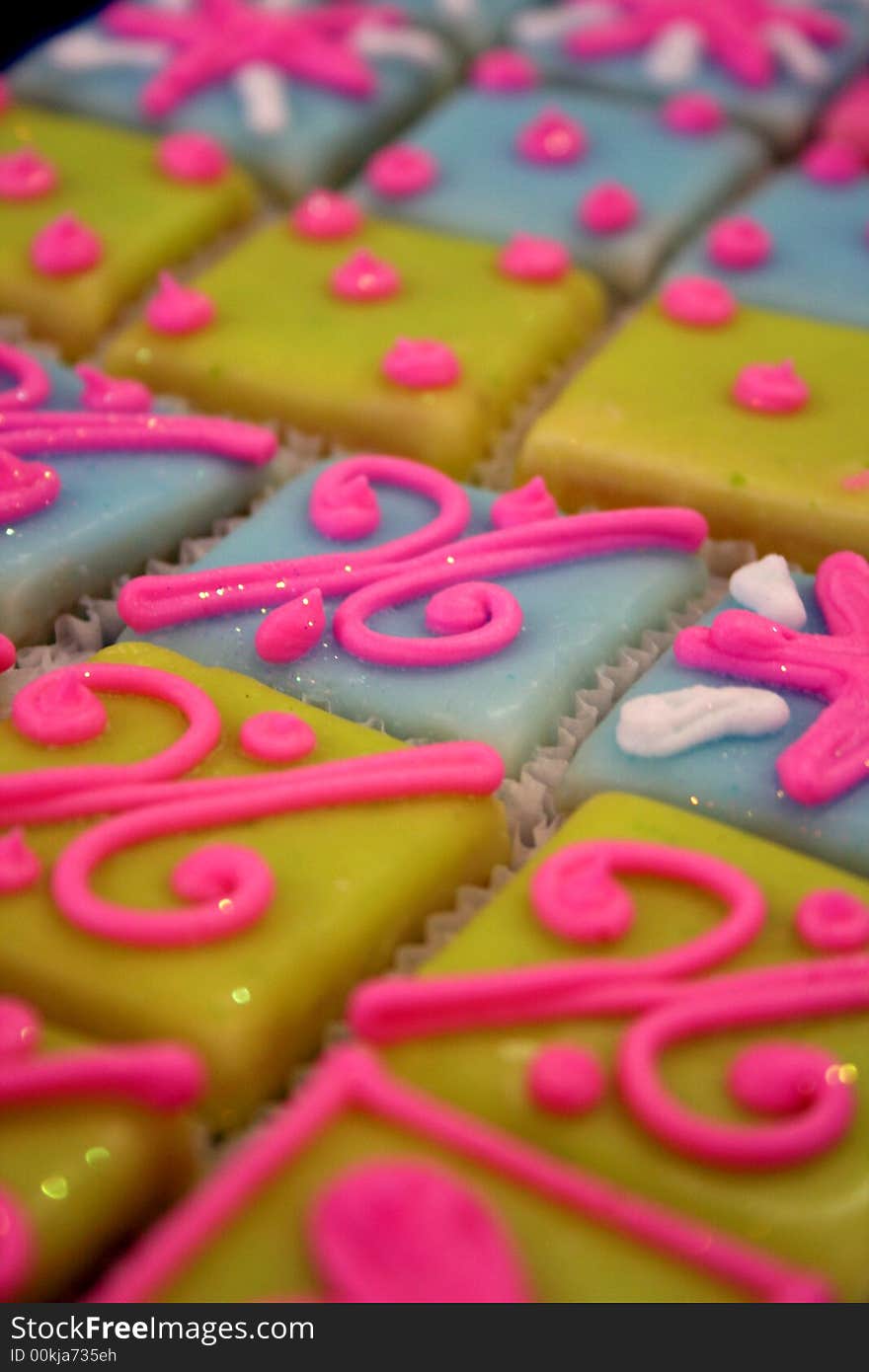 Platter of freshly baked, brightly colored square cupcakes. Platter of freshly baked, brightly colored square cupcakes