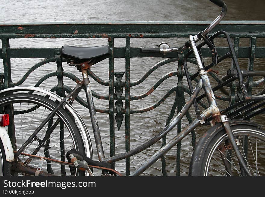 An old rusty bike along the canal in Amsterdam, Holland