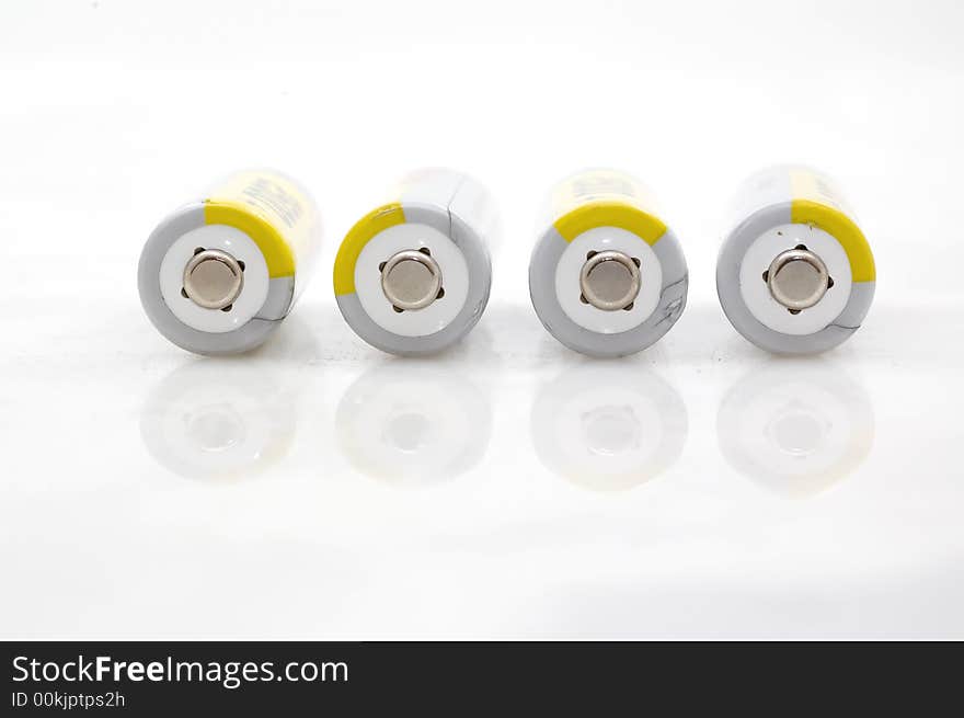 Four AA batteries on white background.