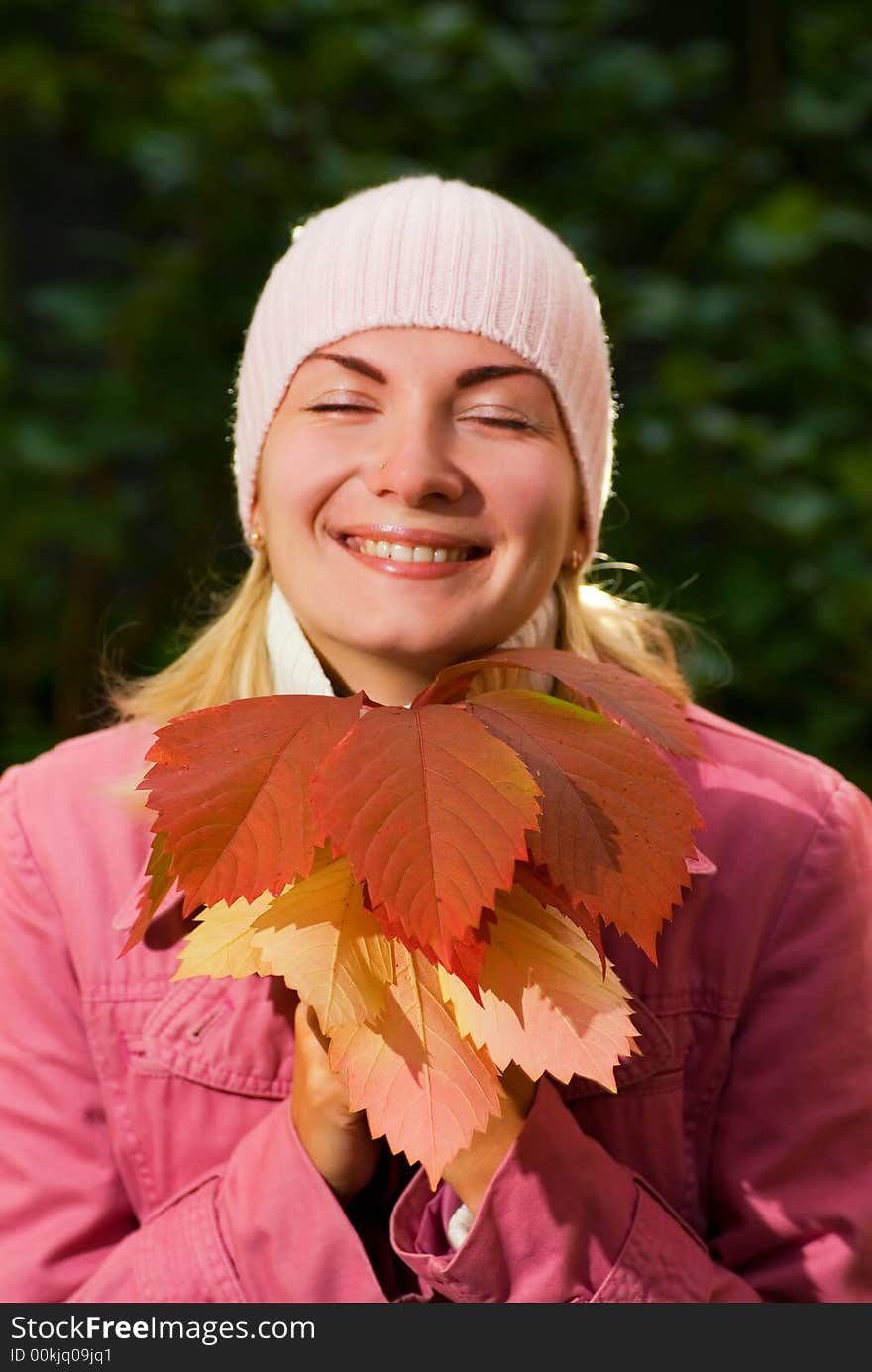 Young girl with autumn leaves