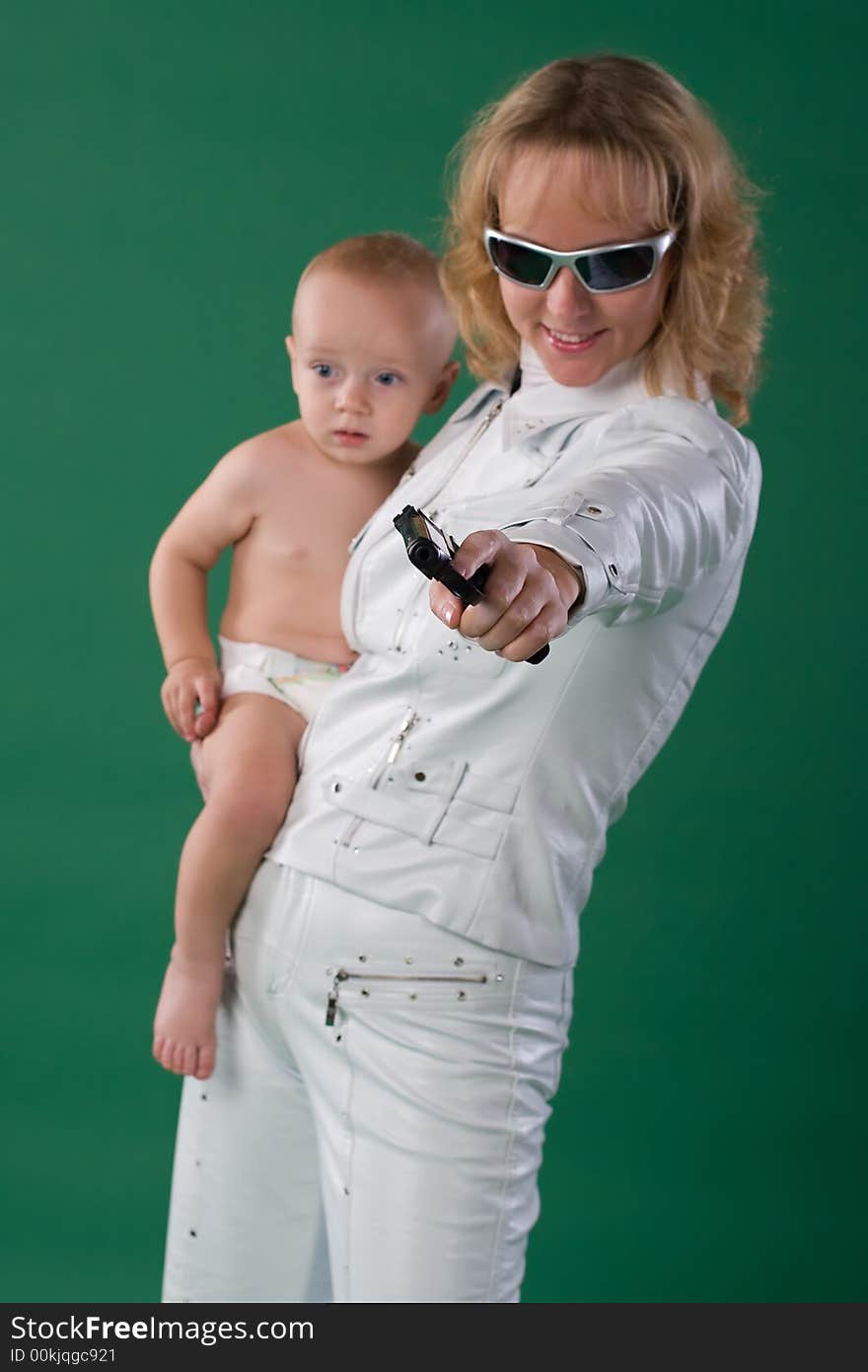 Woman with gun holds her son. Woman with gun holds her son