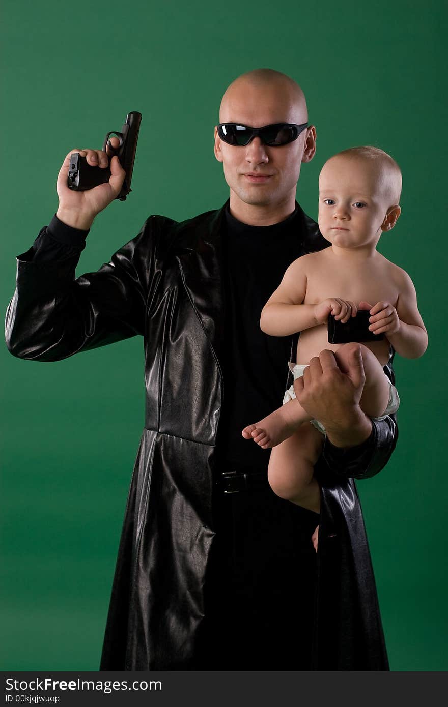 Man with gun holds his son. Man with gun holds his son