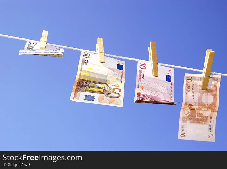 Photo of money hanging on the clothesline on the blue sky. Photo of money hanging on the clothesline on the blue sky