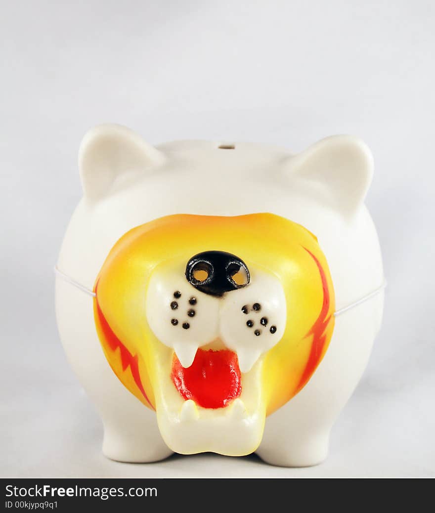 White piggy bank wearing a tiger/lion mask. White piggy bank wearing a tiger/lion mask.