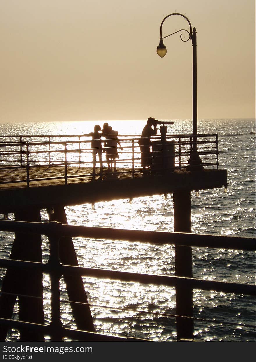 People on LA pier at sunset