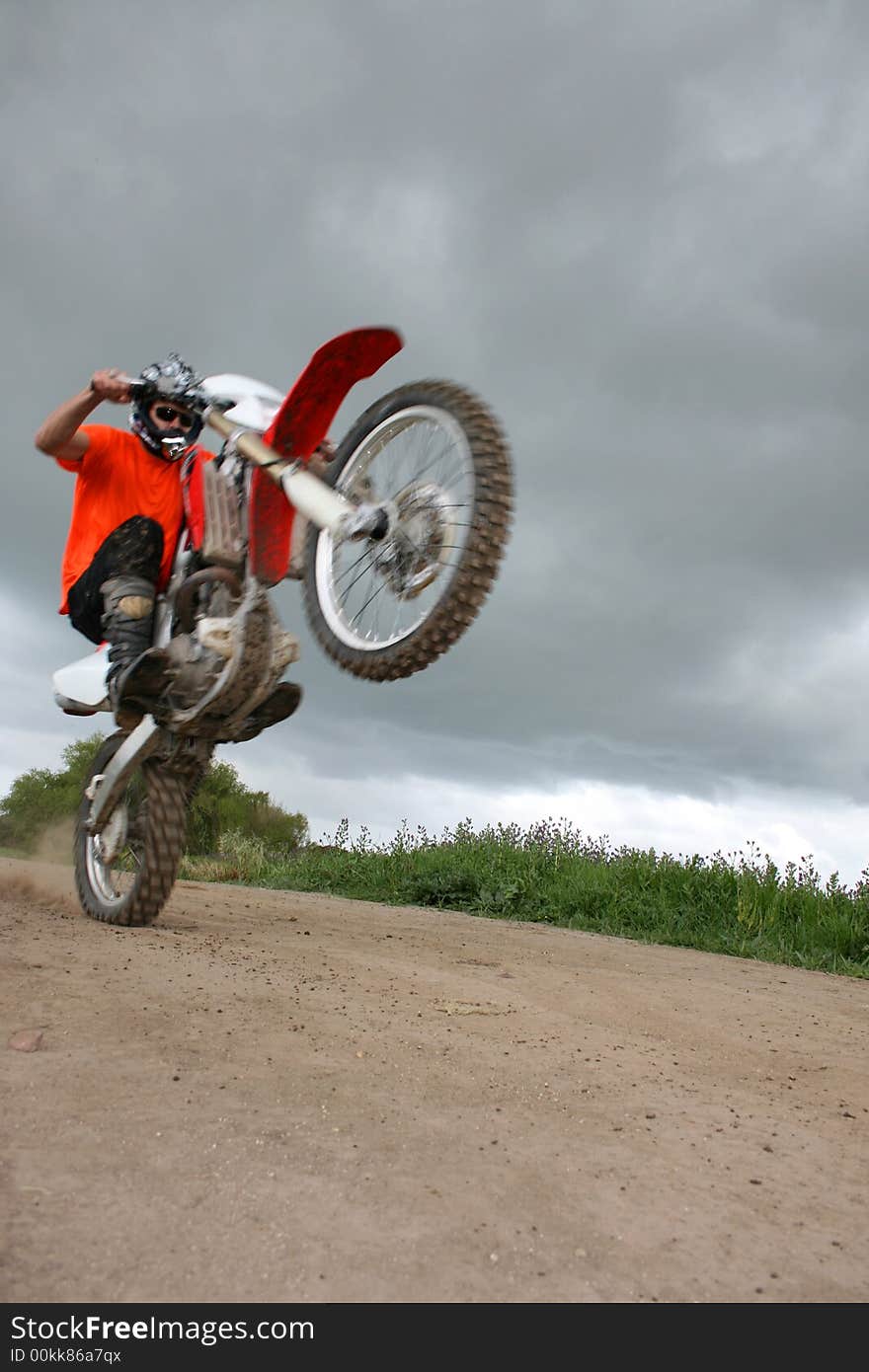 Young biker on an off-road bike doing tricks. Young biker on an off-road bike doing tricks