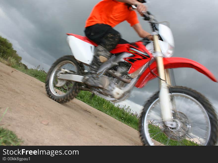 Moving bike in a close-up view against dark cloudy skies