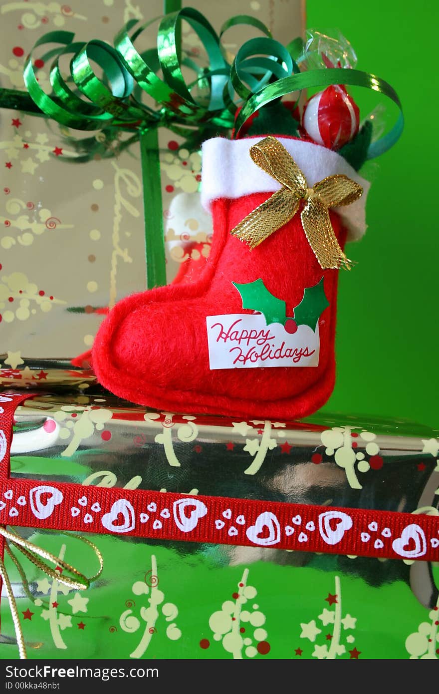 Miniature Christmas Stocking on a gold wrapped gift. Miniature Christmas Stocking on a gold wrapped gift