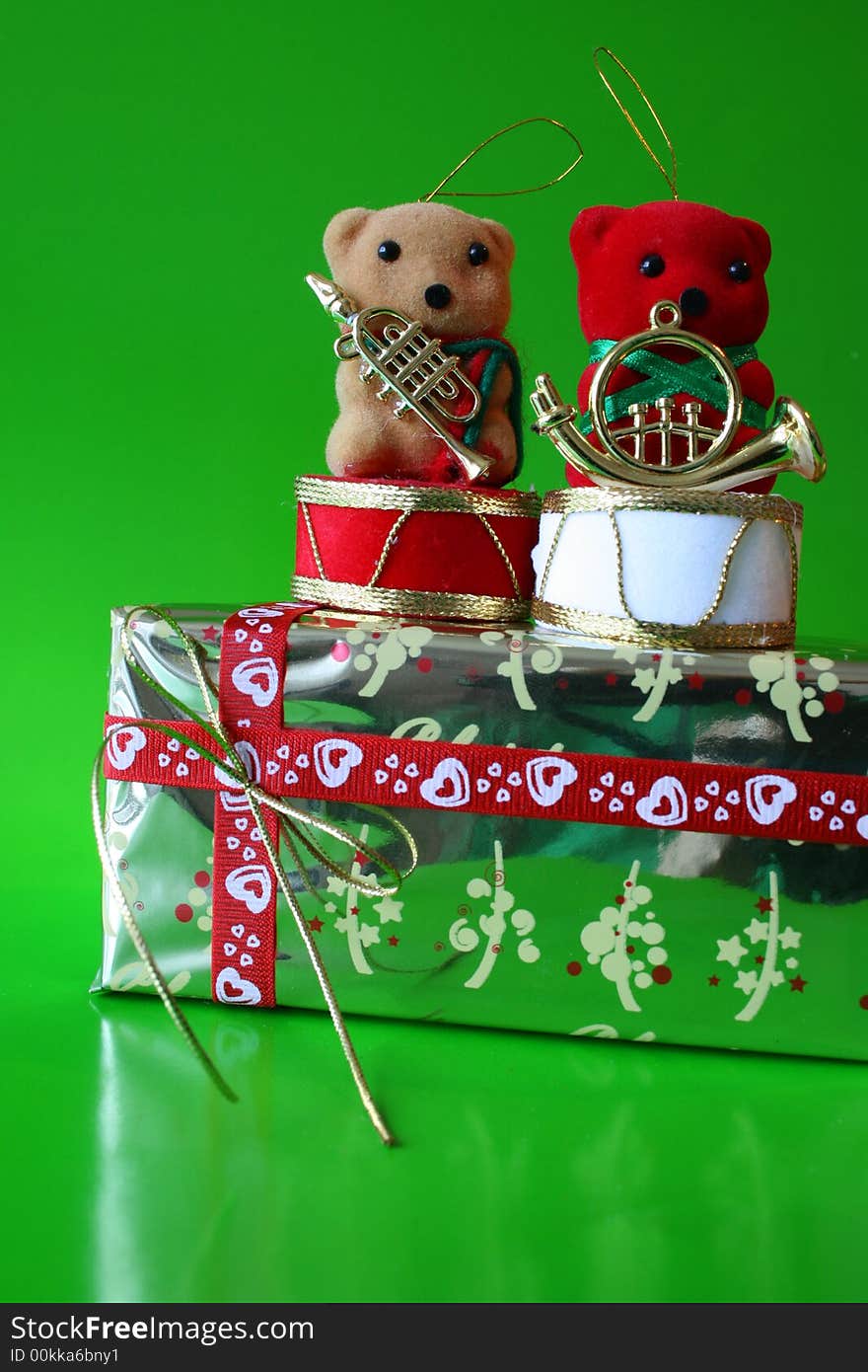 Two bears on a christmas gift, red teddy infront