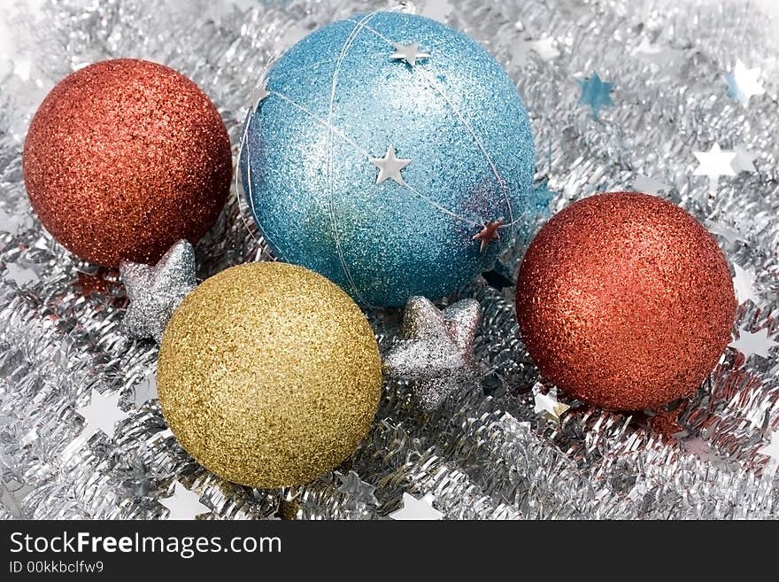 Blue, red and golden christmas balls on silver garlan with silver stars.