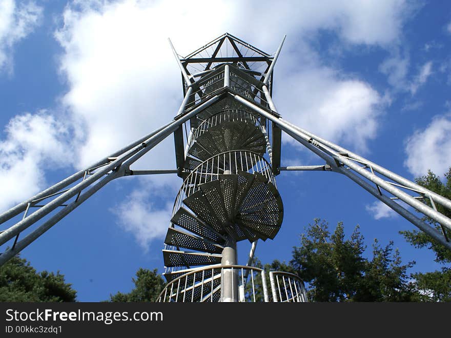 Metal winding staircase against a blue sky. Metal winding staircase against a blue sky.