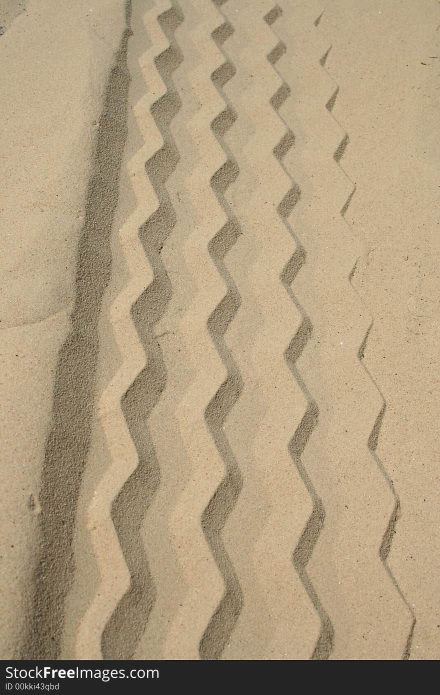 A Tire Track in the clean white sand. A Tire Track in the clean white sand