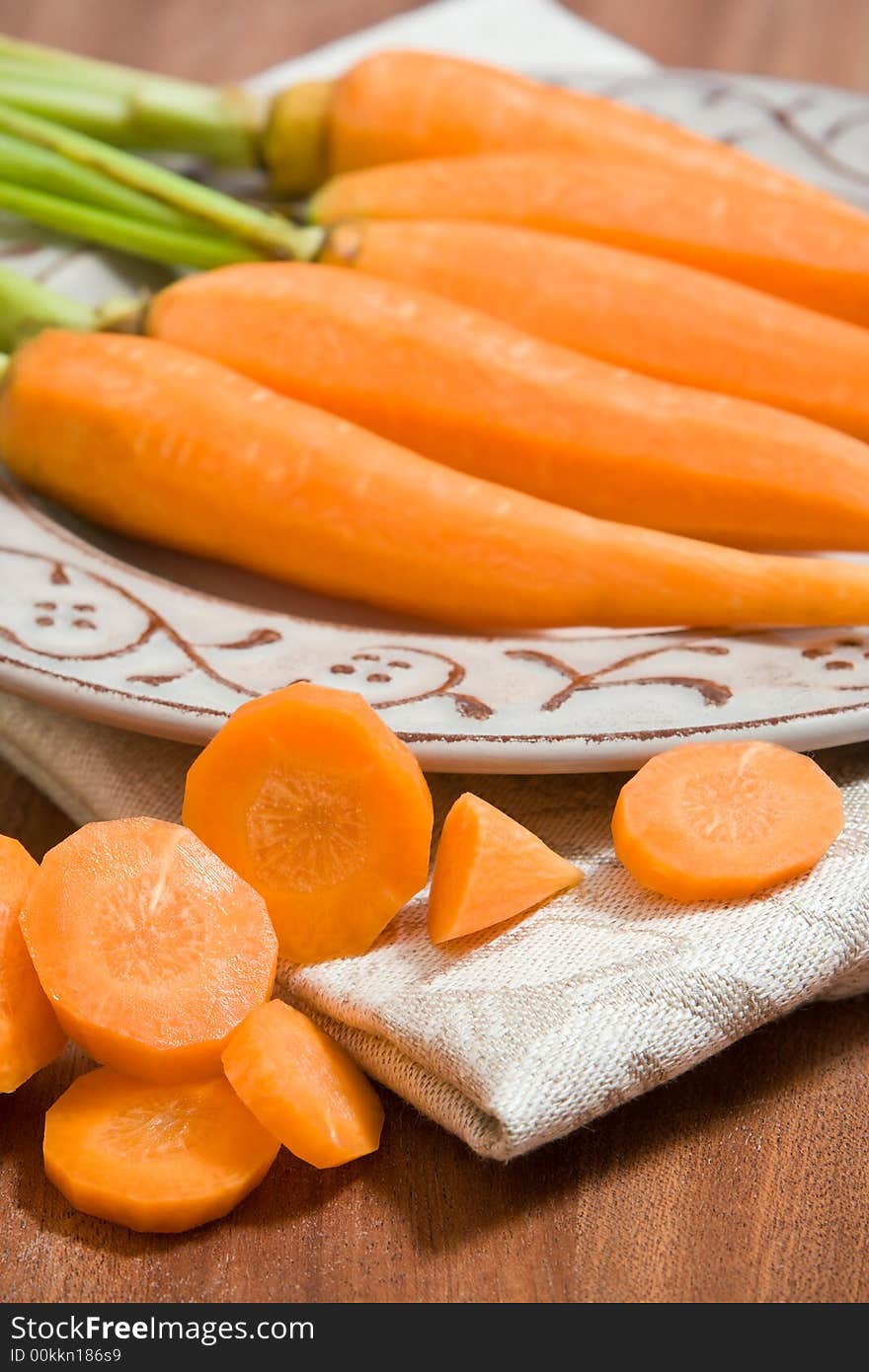 Fresh carrots on the grey plate