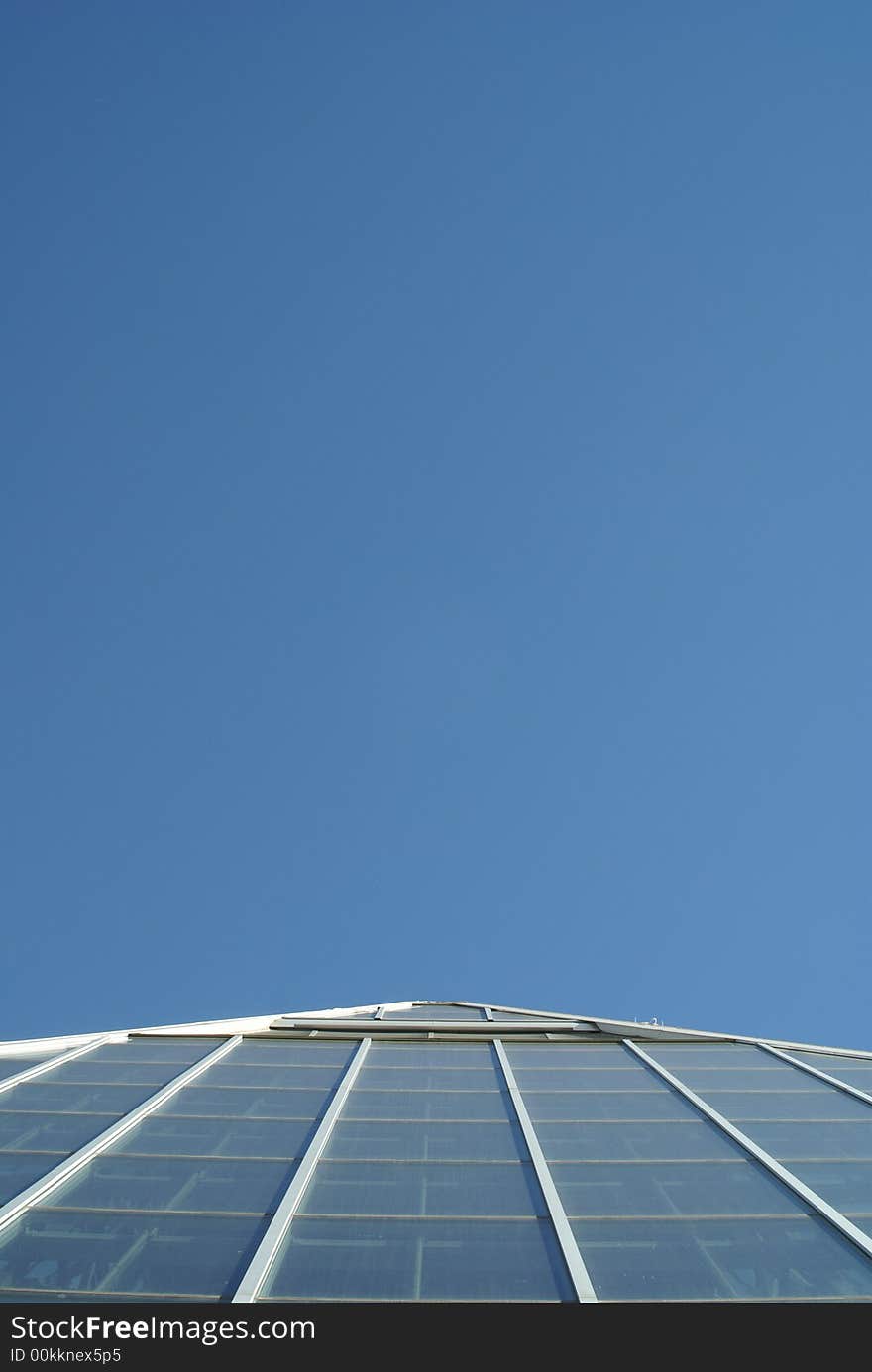 Top of glass pyramid against a blue sky. Top of glass pyramid against a blue sky