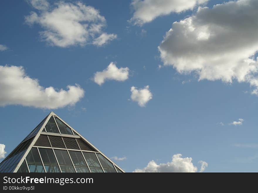 Glass Pyramid  Against a Cloudy Sky. Glass Pyramid  Against a Cloudy Sky