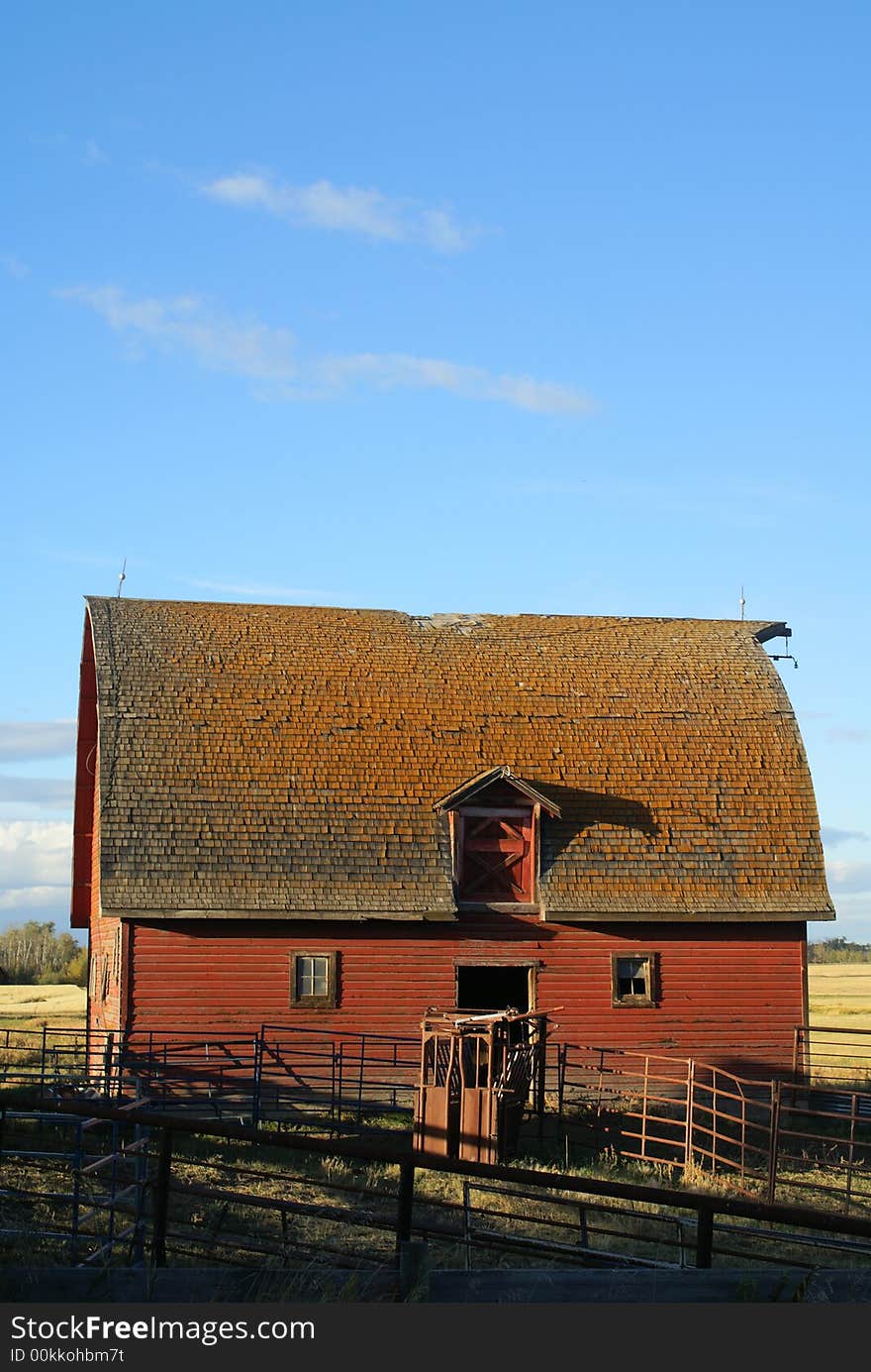 1900s barn in sunset with cattle corrals out front. 1900s barn in sunset with cattle corrals out front