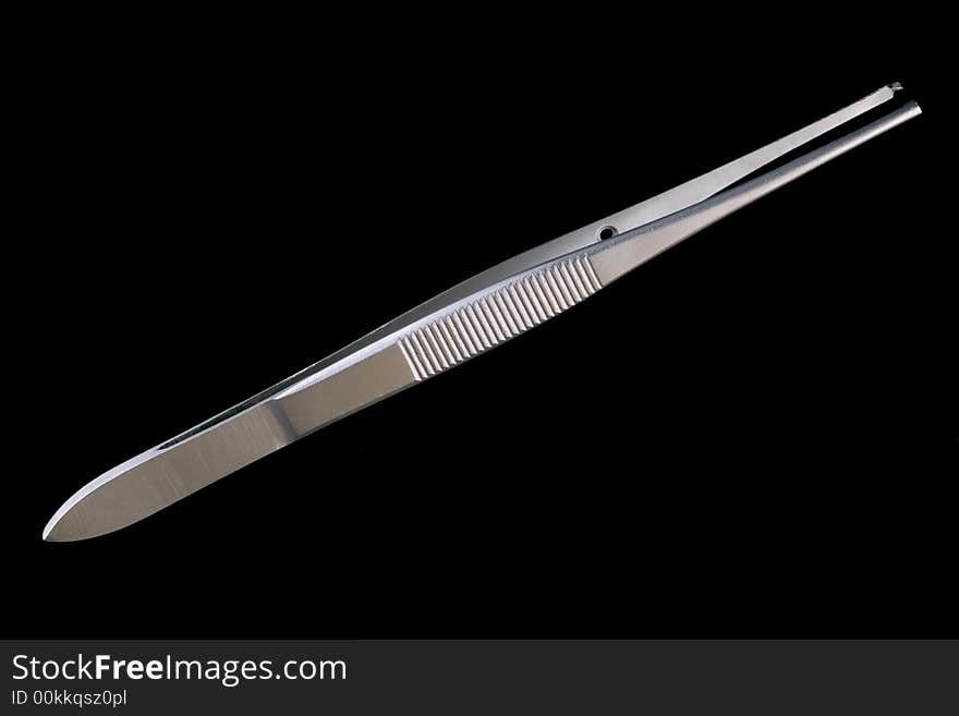 Medical single use tweezers isolated on black background. Medical single use tweezers isolated on black background