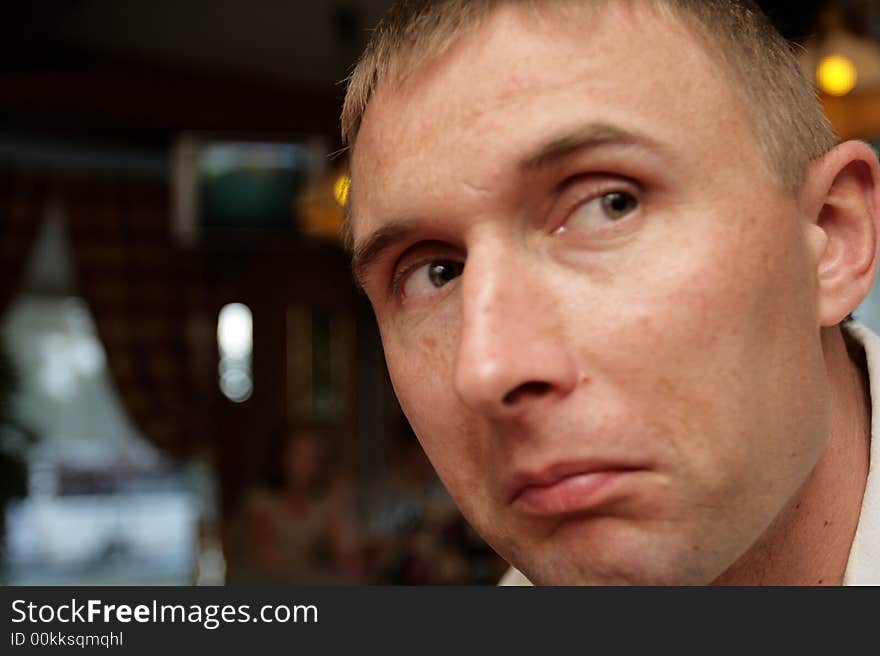 The astonished man in the restaurant in the evening