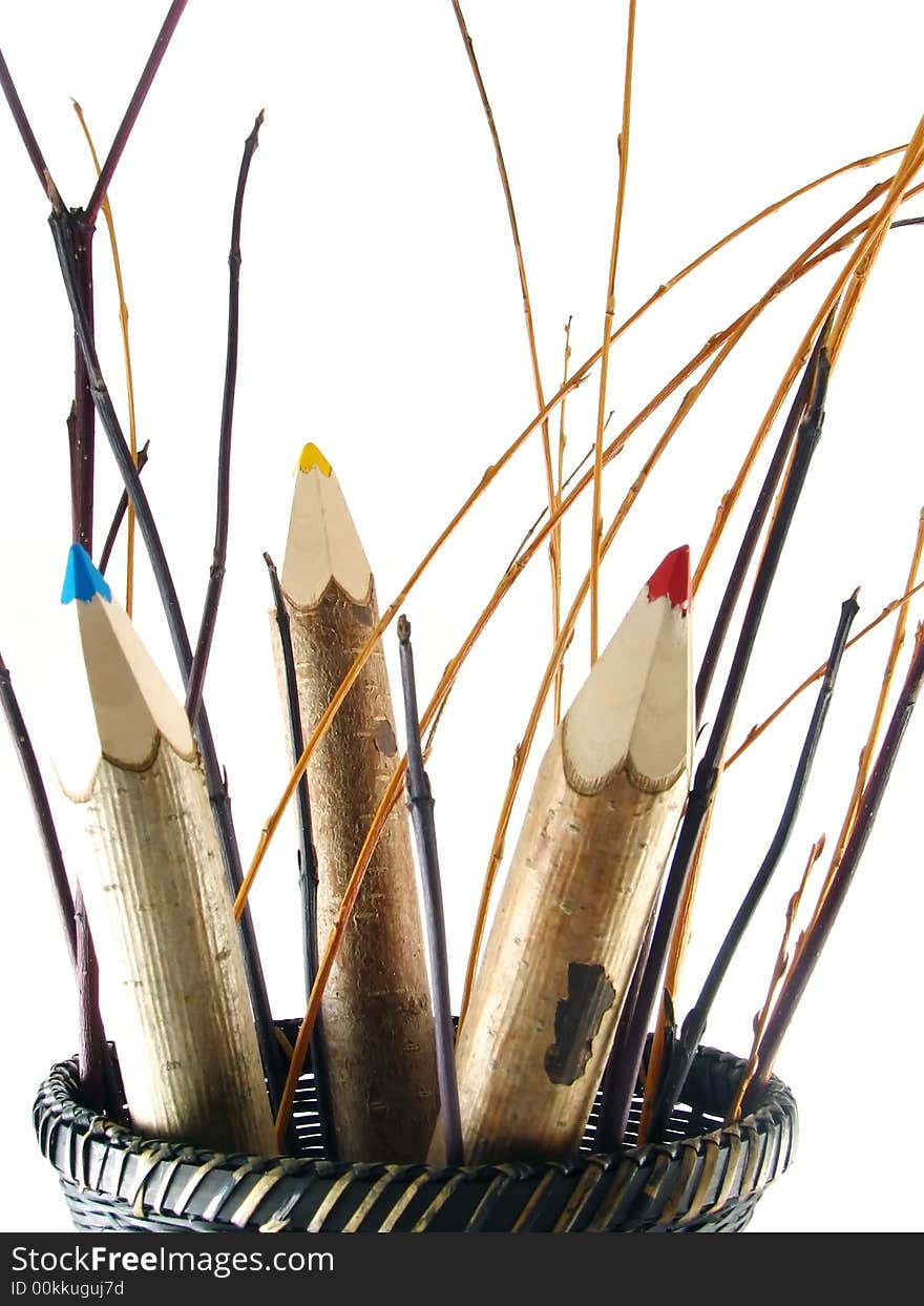 Composition of school and office articles: coloured pencils in basket on white background