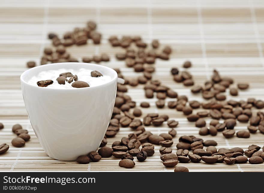 Cup of coffee with beans