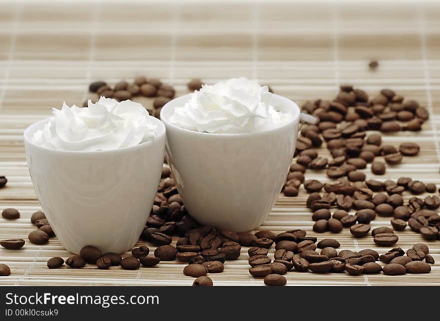 Cups of coffee with beans