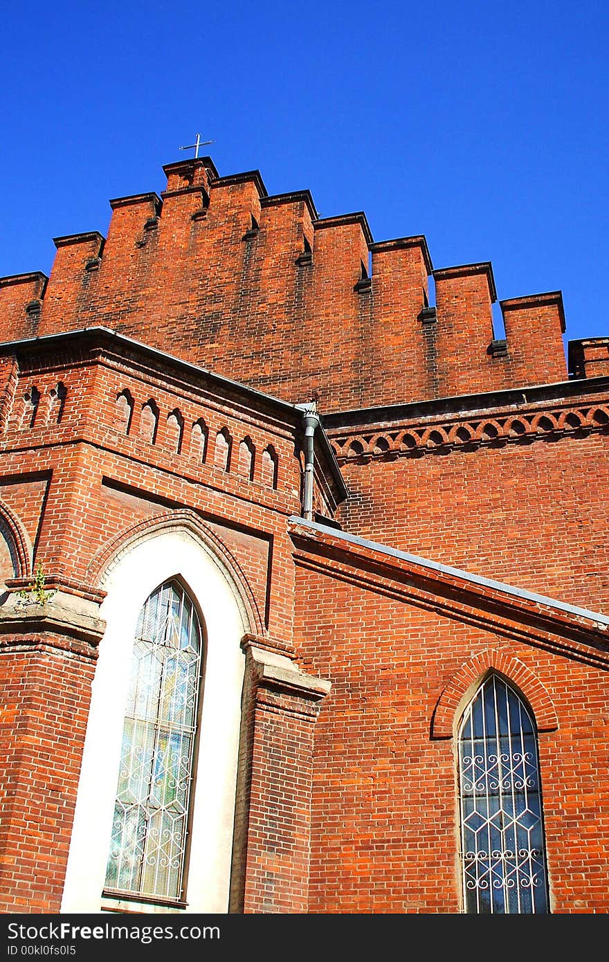 The old temple from a red brick towers to the blue sky. The old temple from a red brick towers to the blue sky