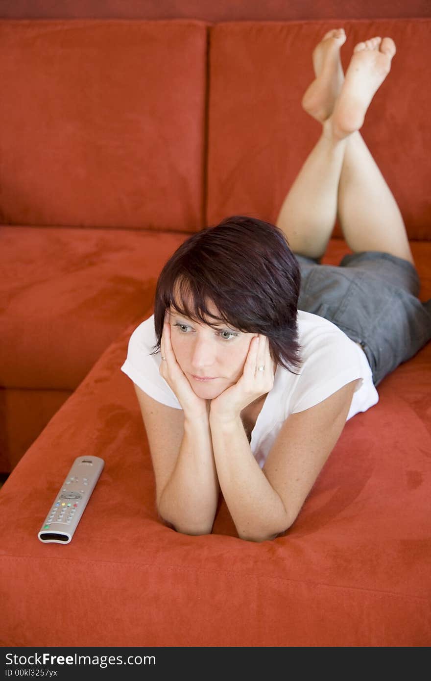 Young girl on a sofa in living room. Young girl on a sofa in living room.