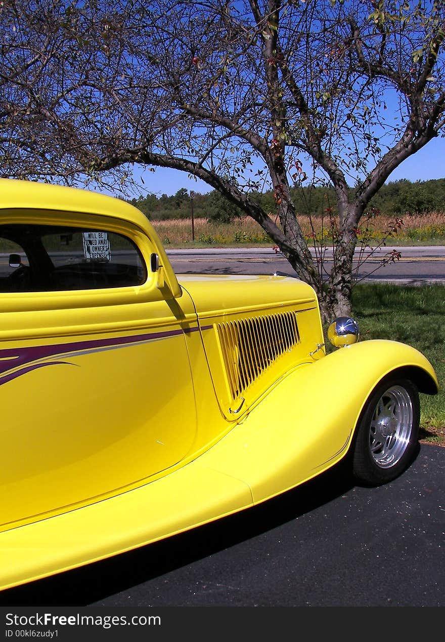 Vintage yellow street rod in mint condition. Vintage yellow street rod in mint condition.
