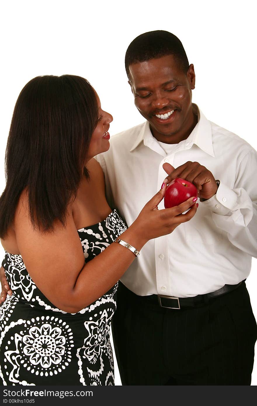 African american couple posing as adam and eve. adam touching the apple from eve. African american couple posing as adam and eve. adam touching the apple from eve