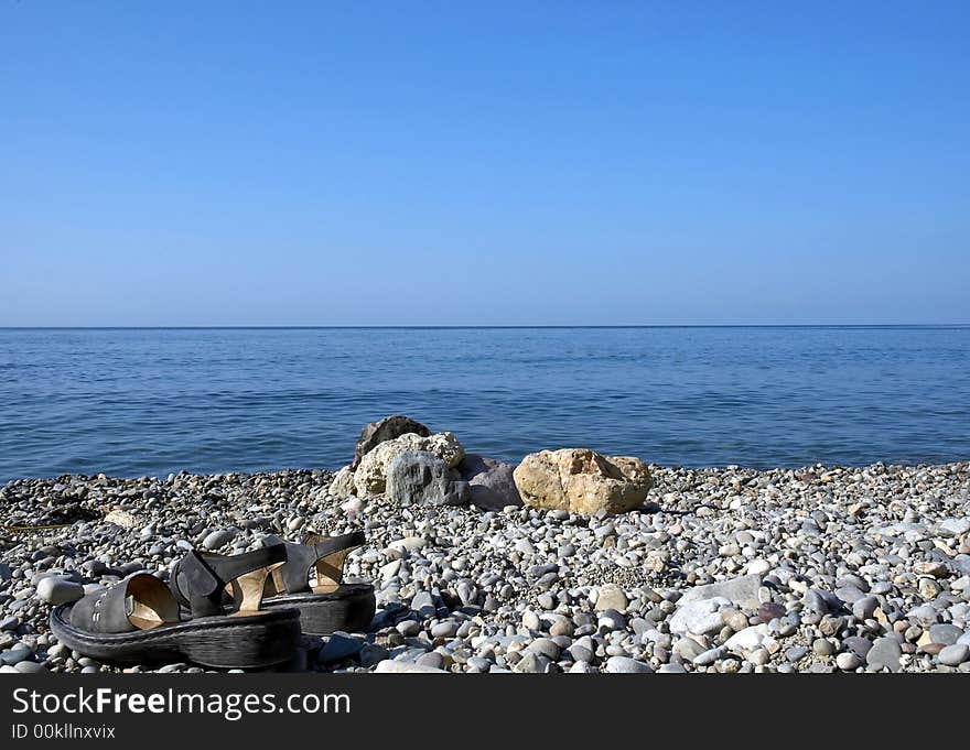 Sea, Sky, Rocks And Sandals